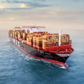 An MSC cargo ship loaded with shipping containers sailing through waters, showcasing MSC's global shipping operations.