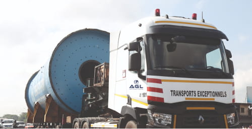 An AGL truck transporting a large cylindrical industrial component.