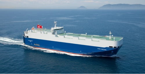 A Gram Car Carriers (GCC) cargo ship sailing through open waters.