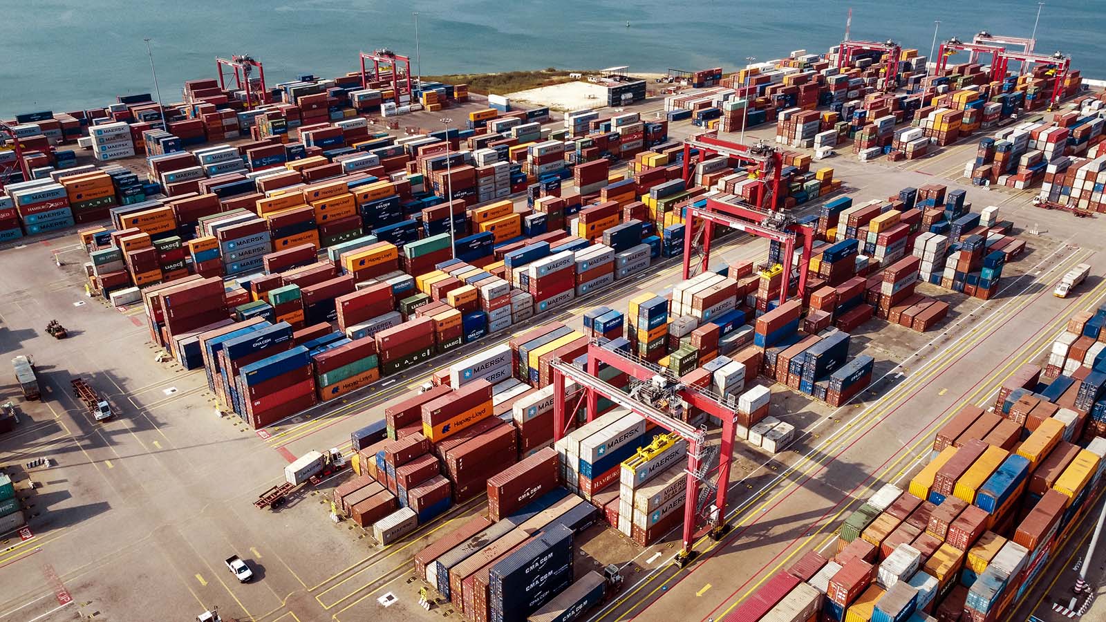 Aerial view of an AGL container terminal with shipping containers and cargo handling cranes.