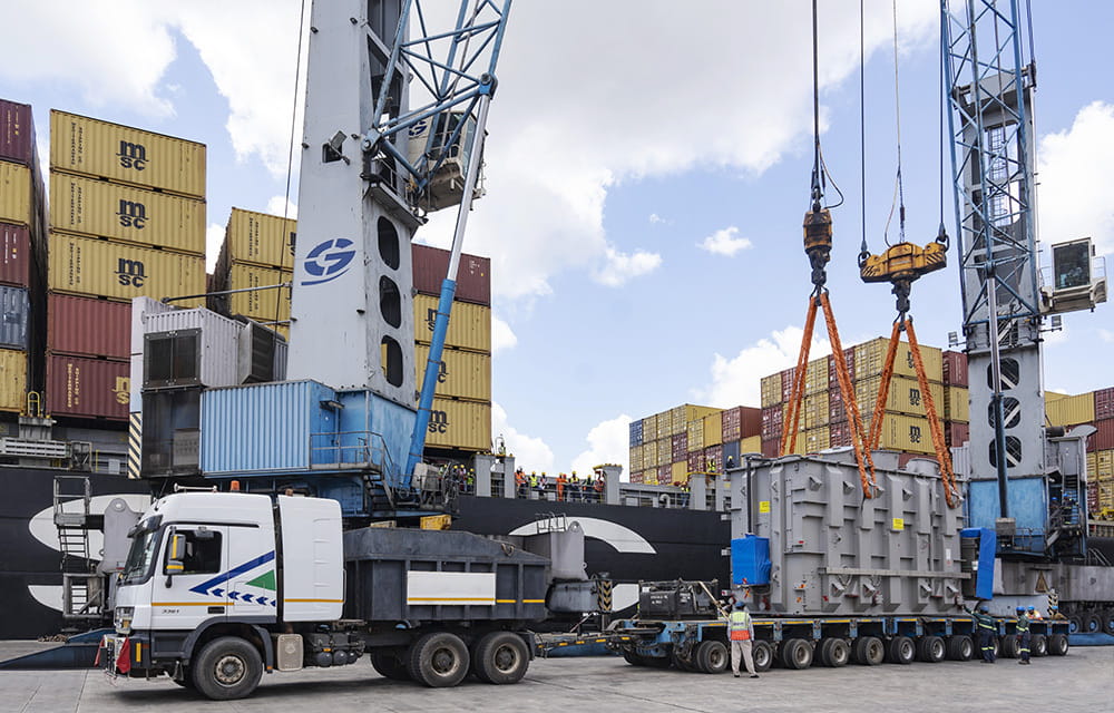 A transformer is being loaded onto a ship, highlighting the process of transporting heavy equipment via sea freight.