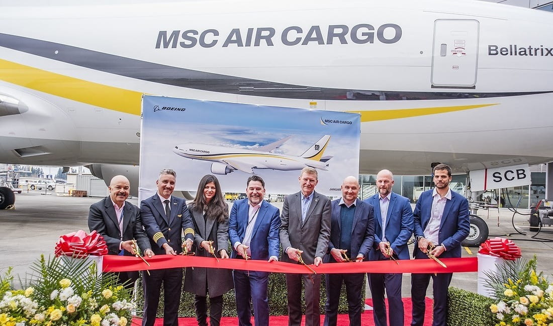MSC Air Cargo representatives cutting a red ribbon in front of the new MSC Air Cargo Bellatrix.