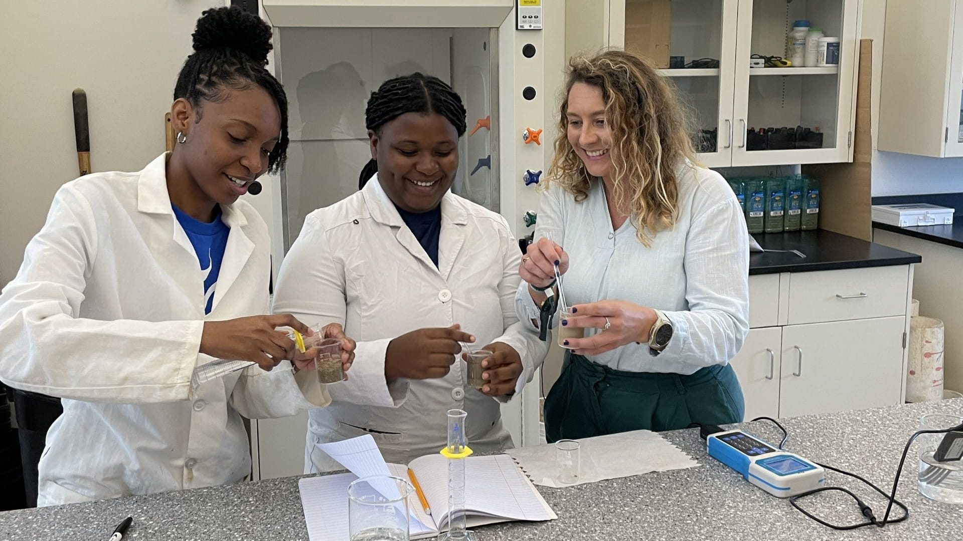 Marine Programme Manager Emeline Bouchet and University of The Bahamas students in the new Small Island Sustainability laboratory (SIS).